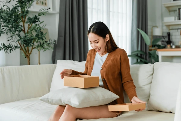 Happy young asian woman opening 600nw 2444572975