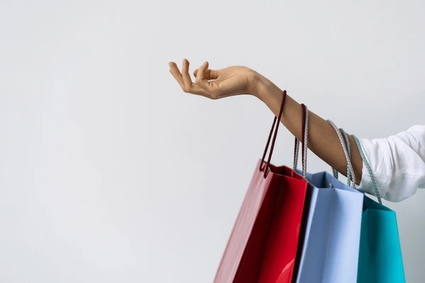 Woman hand holding shopping bags 600nw 2411097529